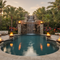 Fire Bowls: Sculptural Fire Features for Outdoors - firebowls around a tropical oasis swimming pool with large rock waterfall