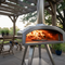 Pizza Ovens for Home & Backyard Cooking -  freestanding stainless steel pizza oven under pergola cooking pizza