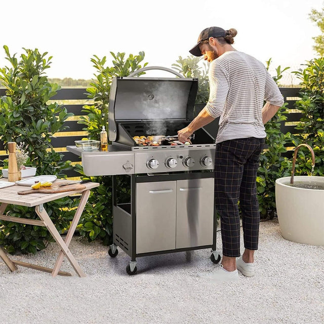 Gas Grills: Premium Outdoor Cooking Equipment - man cooking food on his gas grill